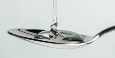 clear syrup being loaded onto a spoon