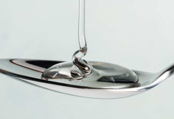 clear syrup being loaded onto a spoon