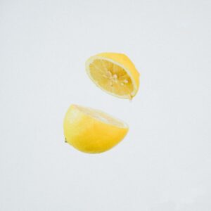 A lemon cut in half and suspended mid-air