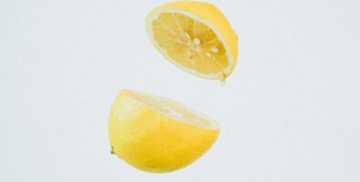 A lemon cut in half and suspended mid-air