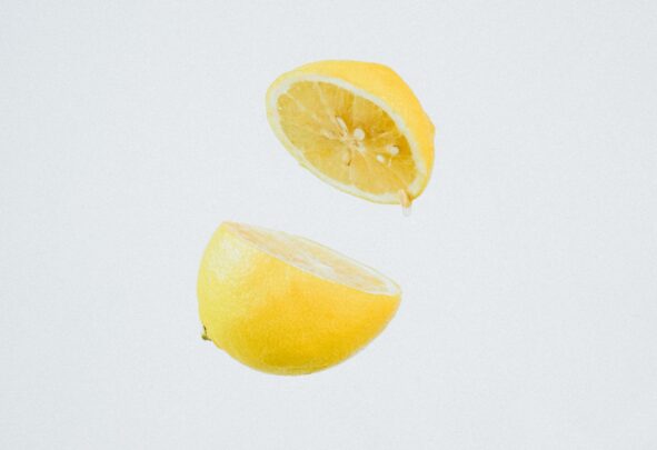 A lemon cut in half and suspended mid-air