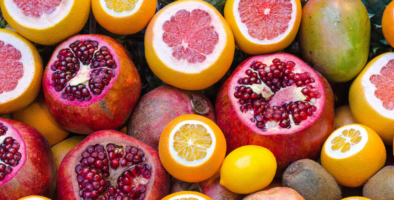 Pomegranate, lemons and mangoes in a pile