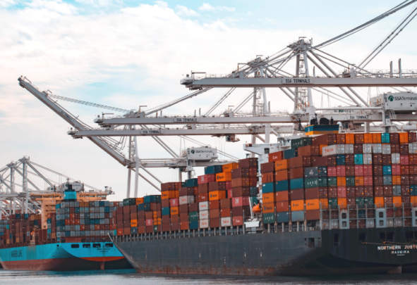 A container ship stacked high with coloured containers