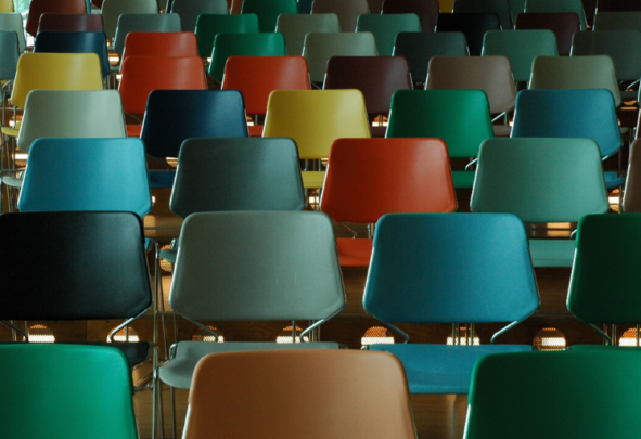 Coloured chairs in an empty lecture hall