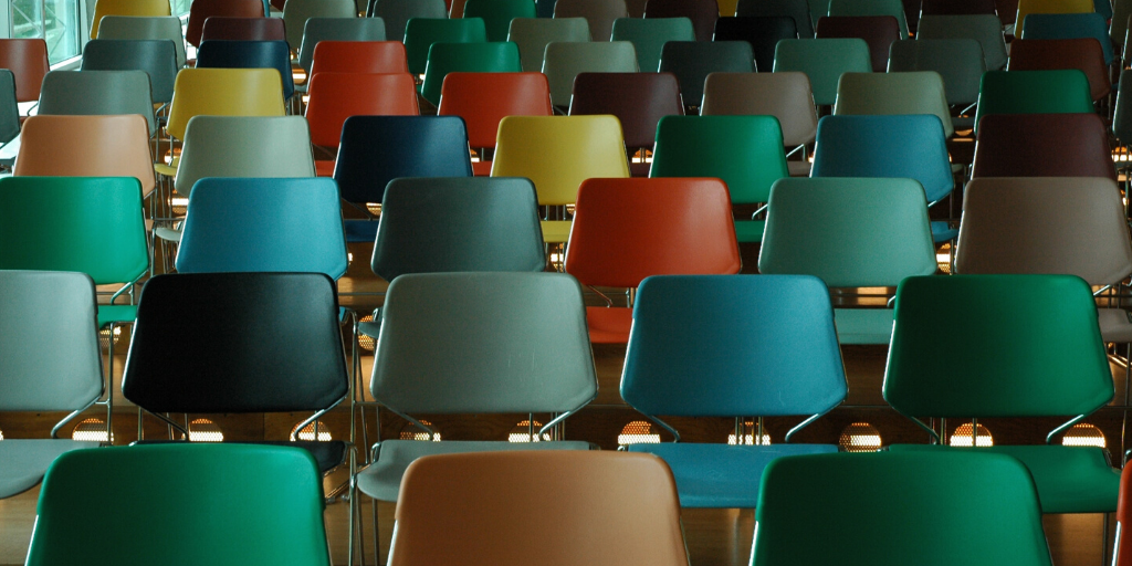 Coloured chairs in an empty lecture hall