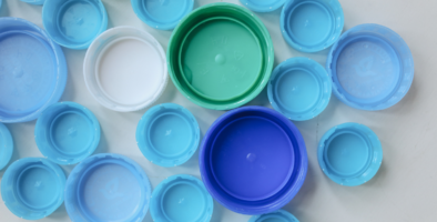 a mixture of blue plastic bottle tops