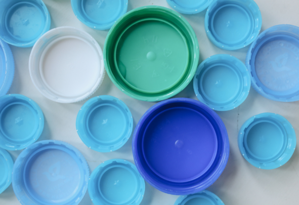 a mixture of blue plastic bottle tops