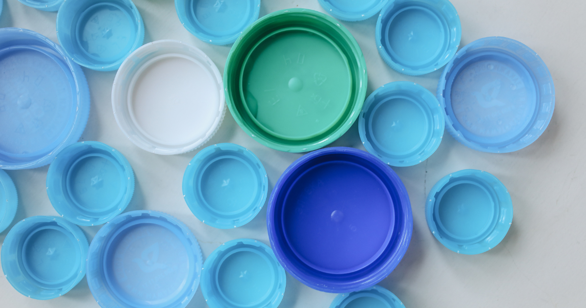 a mixture of blue plastic bottle tops