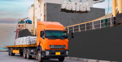 white sugar being moved from a ship to a truck