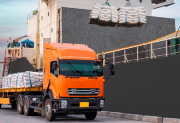 white sugar being moved from a ship to a truck