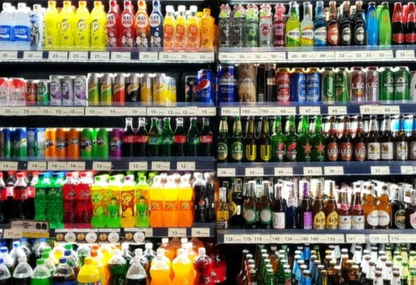 a shelf showing soft beverages and some alcoholic beverages