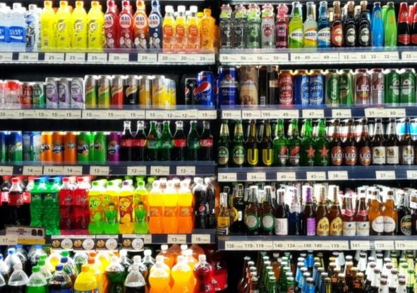 a shelf showing soft beverages and some alcoholic beverages