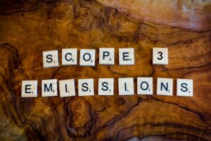 scrabble squares spell out 'scope 3 emissions' on a wooden background