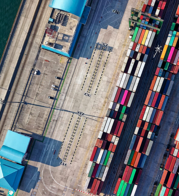 Shipping containers in a port viewed from above.