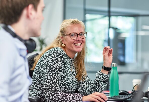 Two colleagues smiling at work