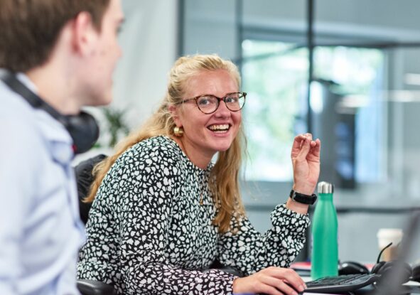 Two colleagues smiling at work